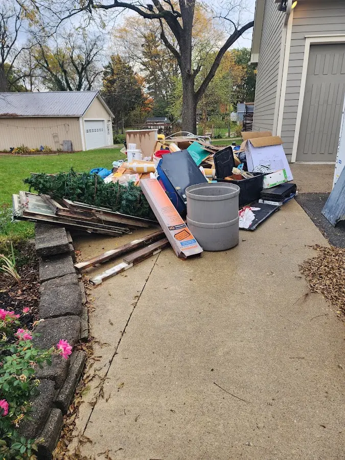 Dumpster being loaded with debris for Estate Cleanout Dumpster Rental in Hillsdale